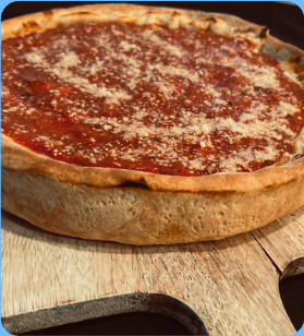 Chi Town Pizza deep dish pizza on a wooden board